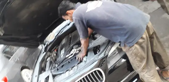 Open engine bay of a BMW being worked on